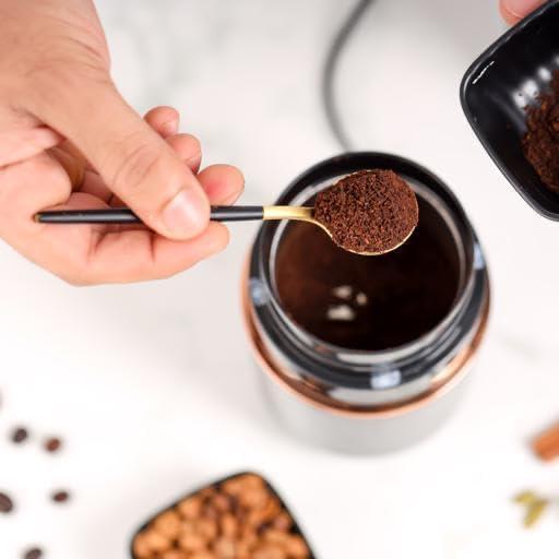 Effortlessly grind coffee beans with the Coffee Grinder- 80 g Capacity featuring a stainless steel jar and ergonomic grip.